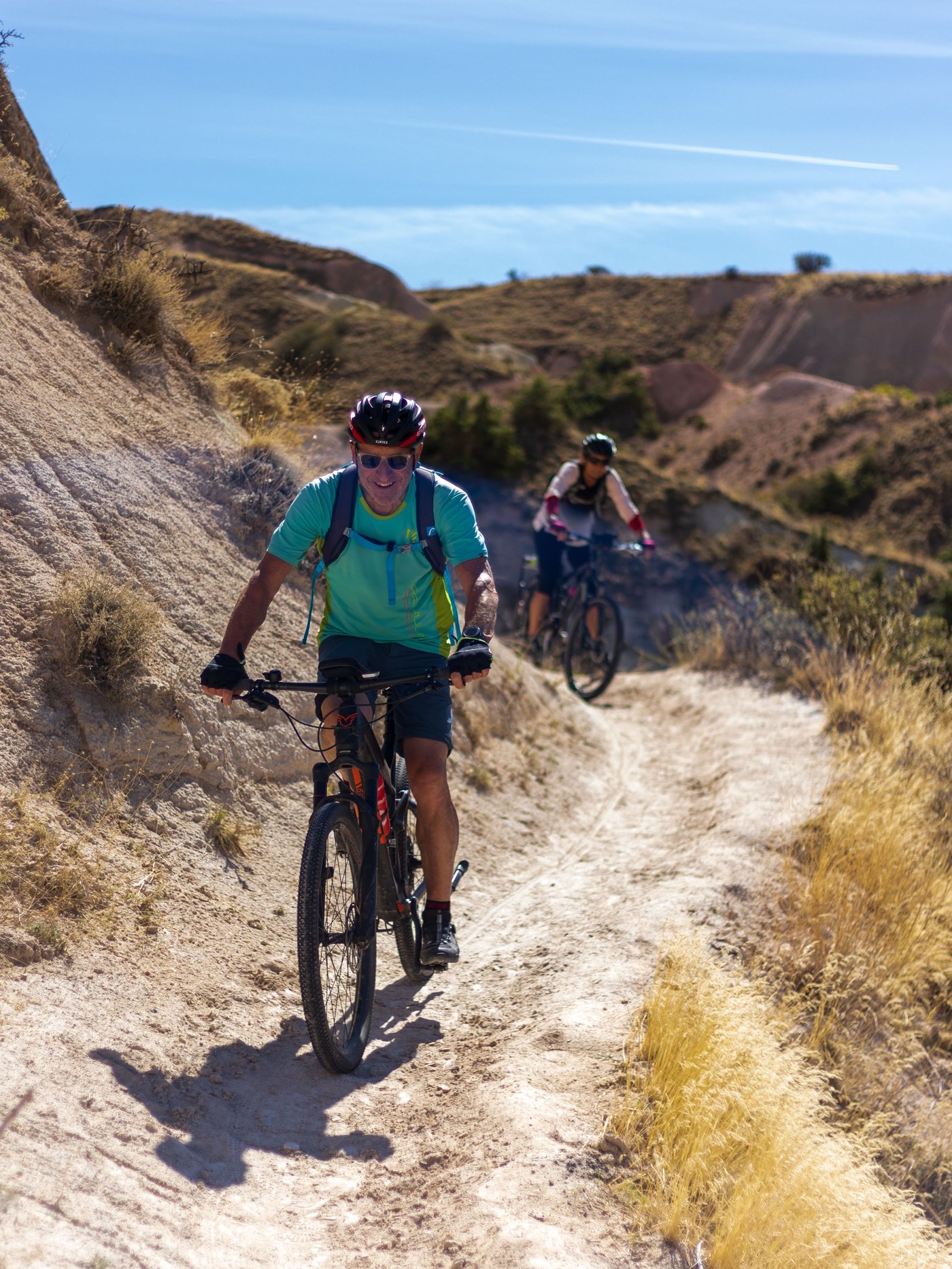 Adult riders on desert singletrack