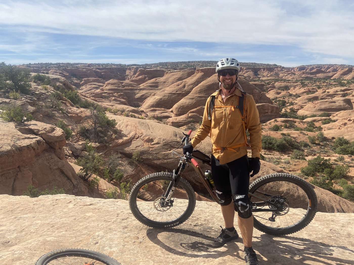 Chris with bike in Moab canyon