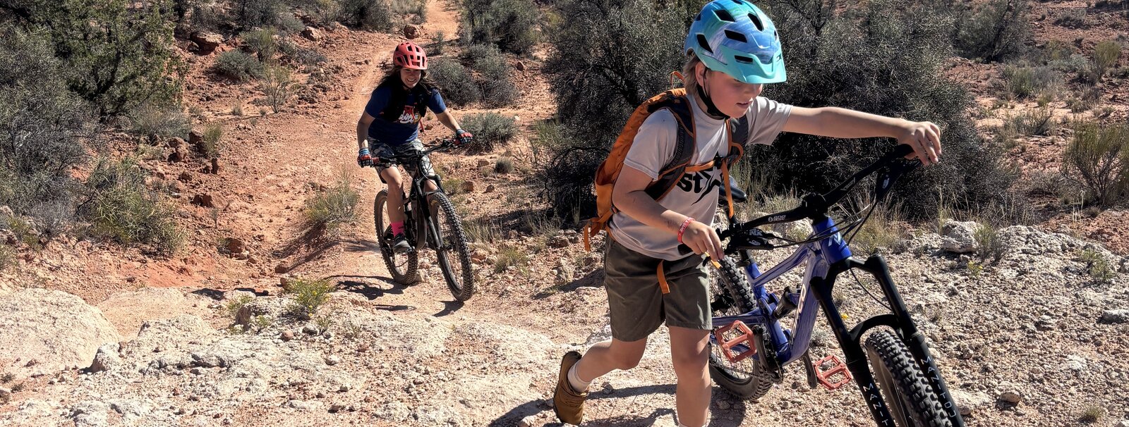 Kids riding singletrack in the Southwest desert